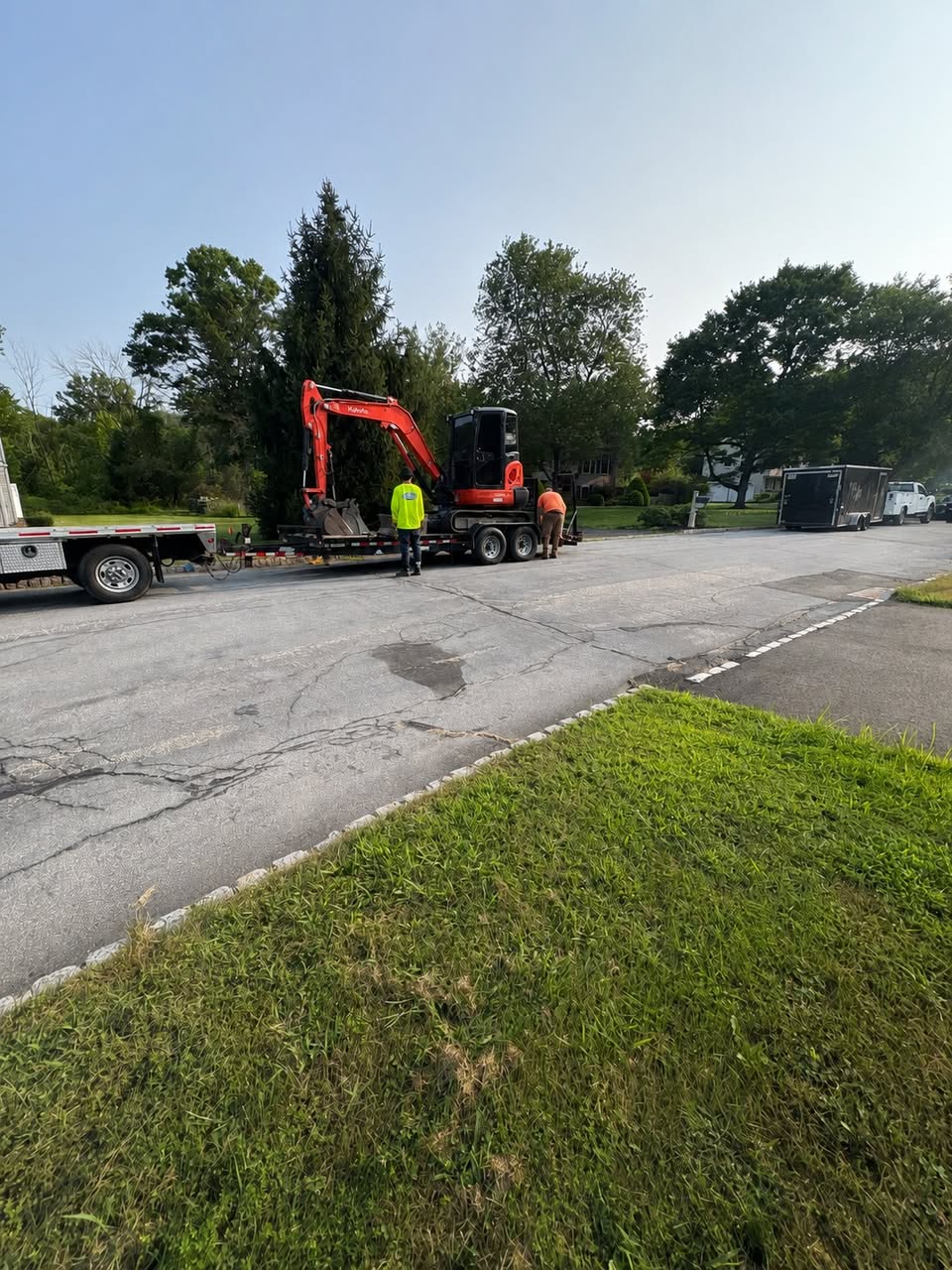 JWSR crew unloading a Kubota excavator off the trailer at a Sussex County NJ job site